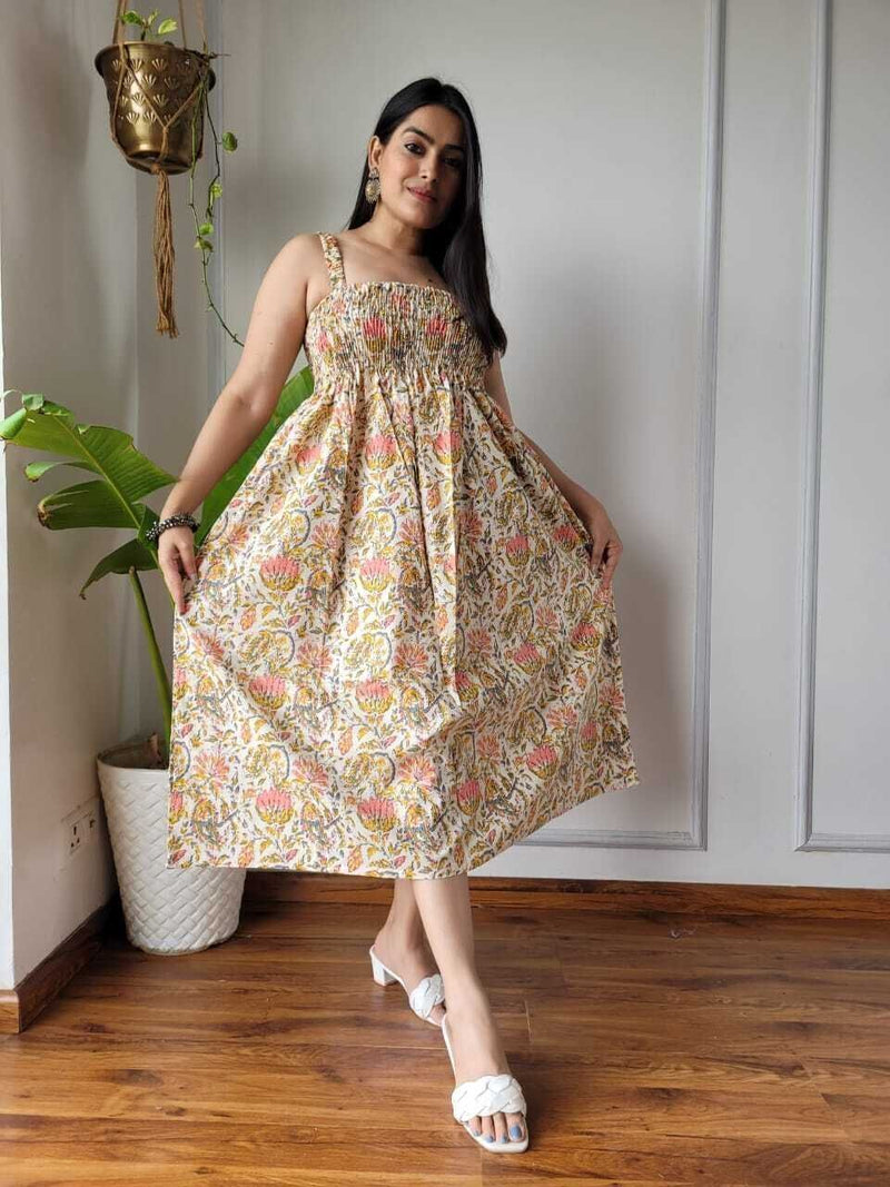 Women wearing cream mustard and pink floral printed smocked cotton midi dress