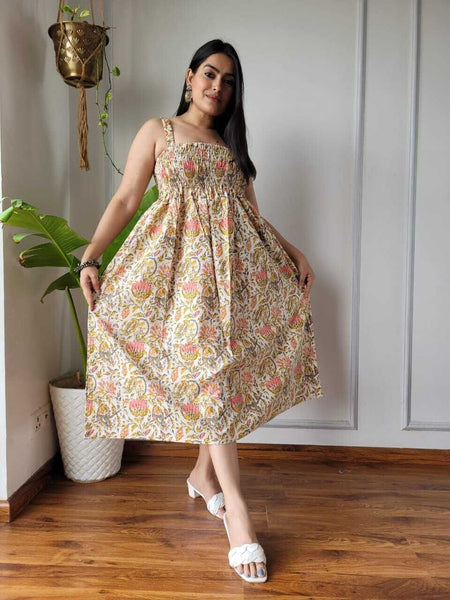 Women wearing cream mustard and pink floral printed smocked cotton midi dress