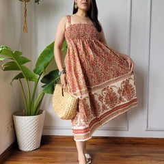 Women wearing rust red and cream paisley printed smocked cotton midi dress