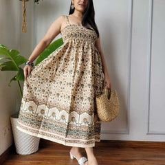 Women wearing olive green and cream floral peacock border printed smocked cotton midi dress