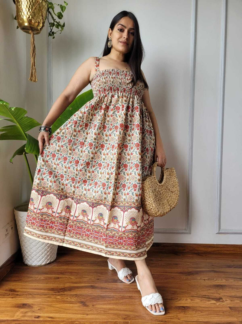 Women wearing red and cream floral peacock border printed smocked cotton midi dress