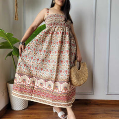 Women wearing red and cream floral peacock border printed smocked cotton midi dress
