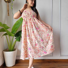 Women wearing cream and pink multi floral printed smocked cotton midi dress