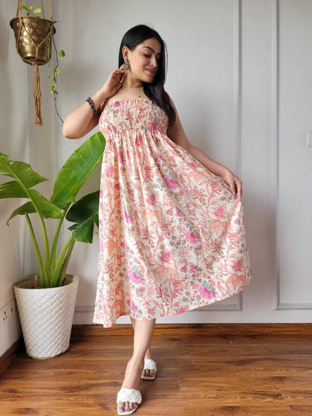 Women wearing cream and pink multi floral printed smocked cotton midi dress