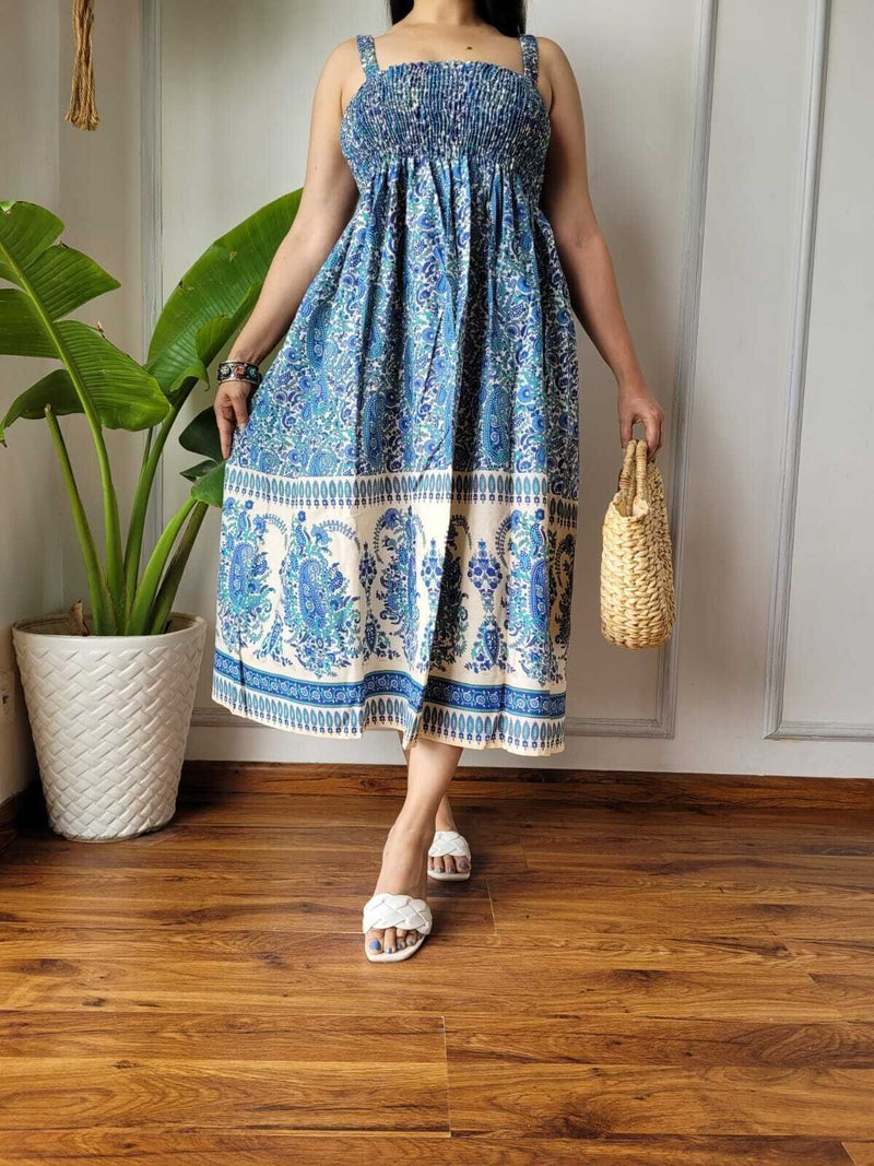 Women wearing blue and cream paisley printed smocked cotton midi dress
