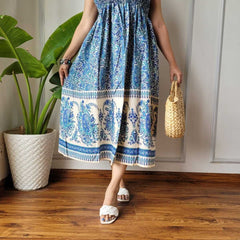 Women wearing blue and cream paisley printed smocked cotton midi dress