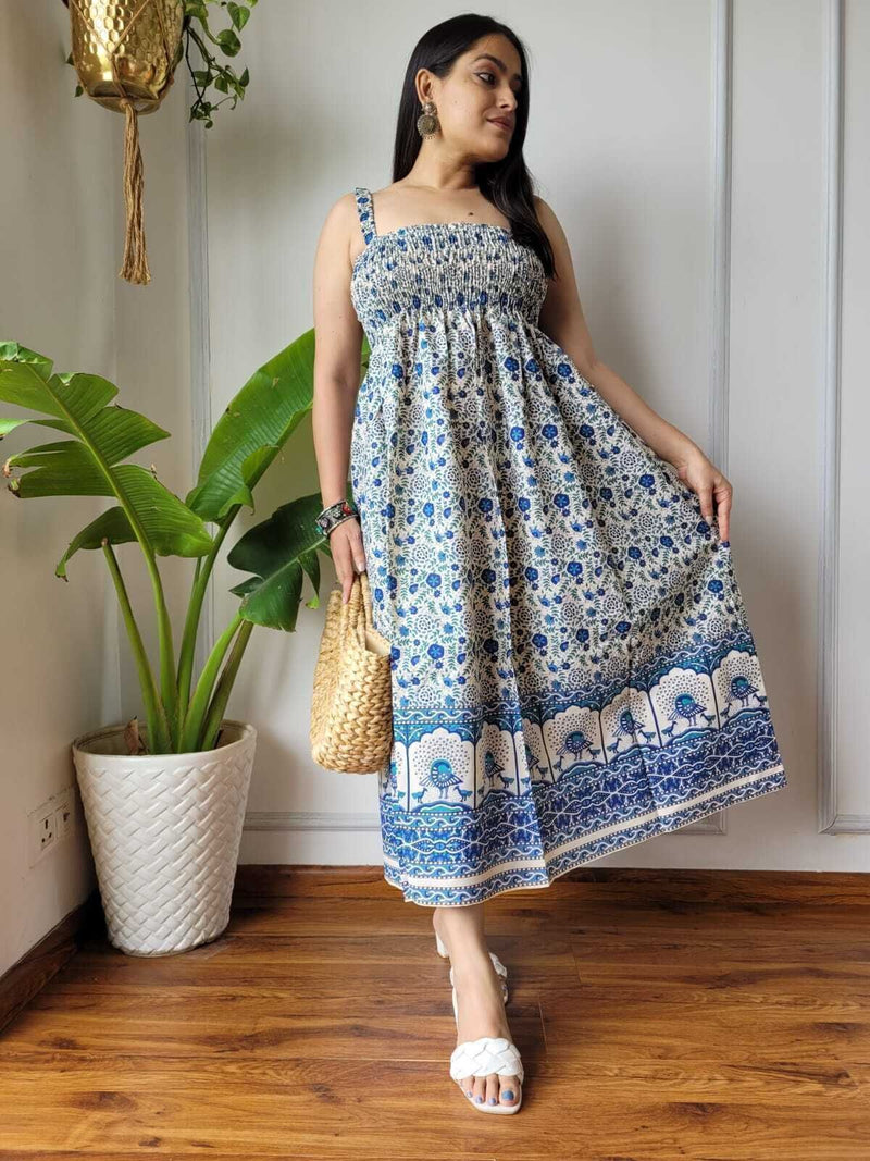 Women wearing blue and white floral peacock border printed smocked cotton midi dress