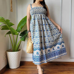Women wearing blue and white floral peacock border printed smocked cotton midi dress