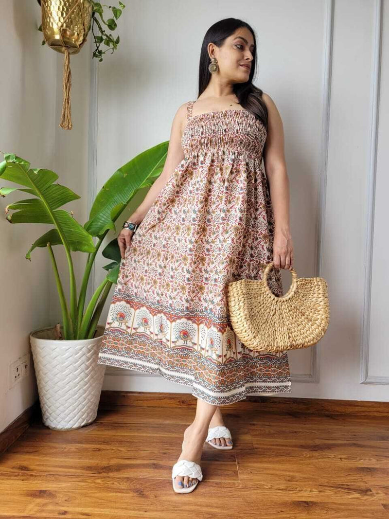 Women wearing rust and cream floral border printed smocked cotton midi dress