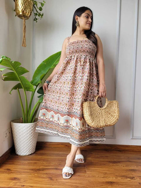 Women wearing rust and cream floral border printed smocked cotton midi dress