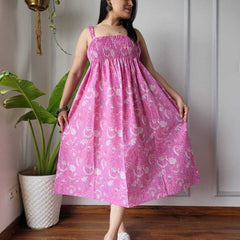Women wearing pink jaal printed smocked cotton midi dress