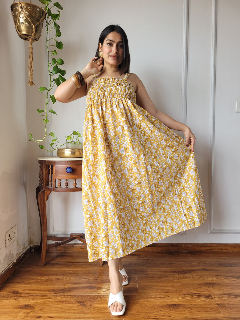 Women wearing mustard yellow floral printed smocked cotton midi dress