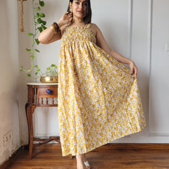 Women wearing mustard yellow floral printed smocked cotton midi dress